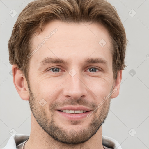 Joyful white young-adult male with short  brown hair and grey eyes