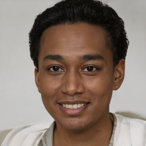 Joyful black young-adult male with short  black hair and brown eyes