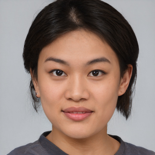 Joyful asian young-adult female with medium  black hair and brown eyes