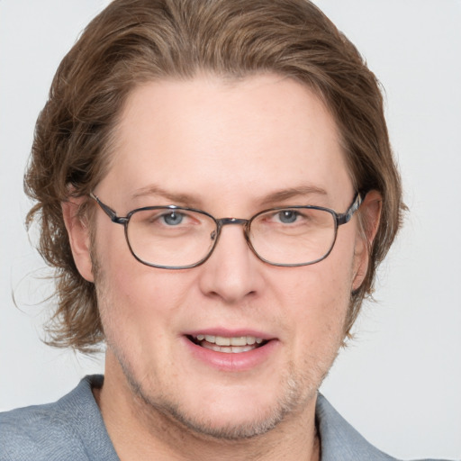 Joyful white adult male with short  brown hair and blue eyes