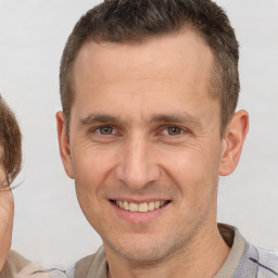 Joyful white adult male with short  brown hair and brown eyes