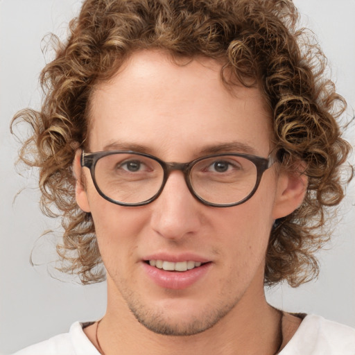 Joyful white young-adult male with short  brown hair and blue eyes