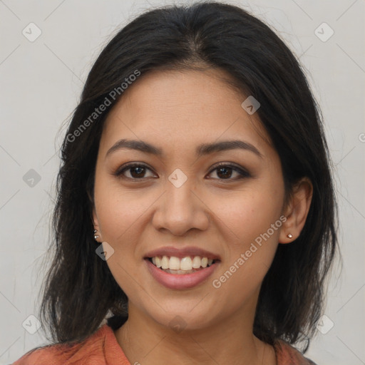 Joyful latino young-adult female with medium  brown hair and brown eyes