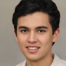 Joyful latino young-adult male with short  brown hair and brown eyes