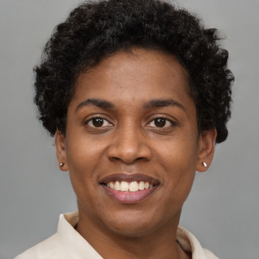 Joyful black young-adult female with short  brown hair and brown eyes
