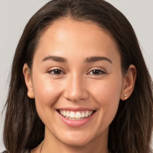 Joyful white young-adult female with long  brown hair and brown eyes