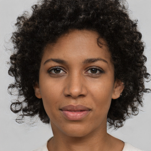 Joyful black young-adult female with medium  brown hair and brown eyes