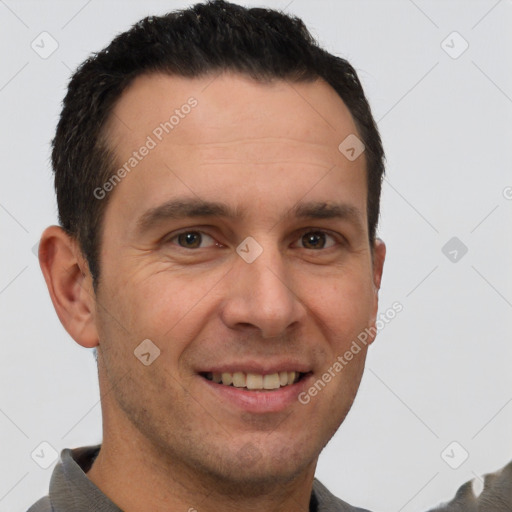 Joyful white adult male with short  brown hair and brown eyes