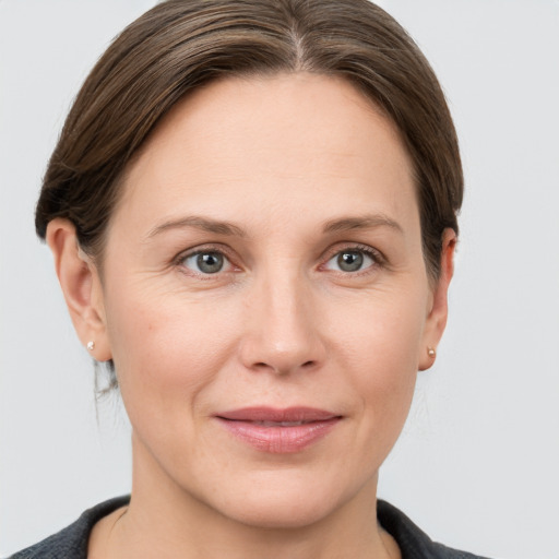 Joyful white adult female with short  brown hair and grey eyes