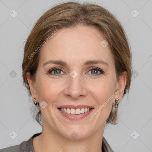 Joyful white adult female with medium  brown hair and grey eyes