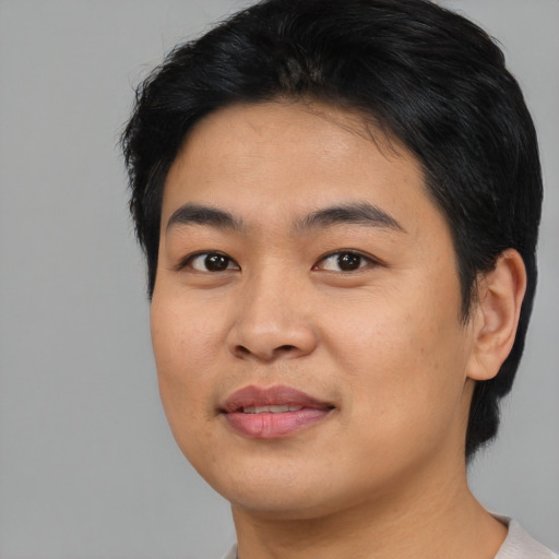 Joyful asian young-adult male with medium  black hair and brown eyes