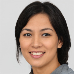 Joyful asian young-adult female with medium  black hair and brown eyes