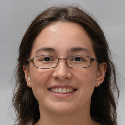 Joyful white adult female with medium  brown hair and grey eyes