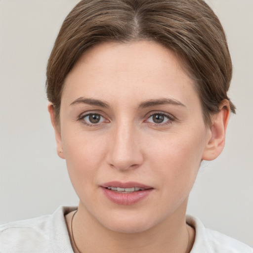 Joyful white young-adult female with short  brown hair and grey eyes