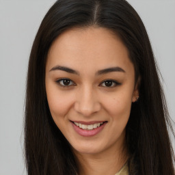 Joyful latino young-adult female with long  brown hair and brown eyes