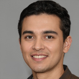 Joyful white young-adult male with short  black hair and brown eyes