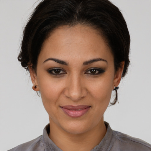 Joyful latino young-adult female with medium  brown hair and brown eyes