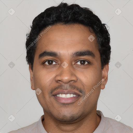 Joyful black young-adult male with short  black hair and brown eyes