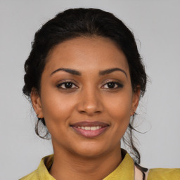 Joyful latino young-adult female with medium  brown hair and brown eyes