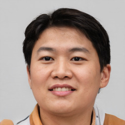 Joyful asian young-adult male with short  black hair and brown eyes