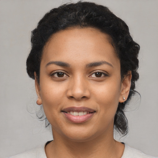 Joyful latino young-adult female with short  black hair and brown eyes