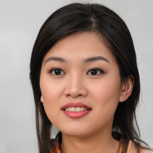 Joyful asian young-adult female with medium  black hair and brown eyes