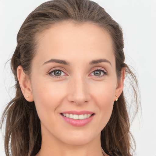 Joyful white young-adult female with long  brown hair and blue eyes