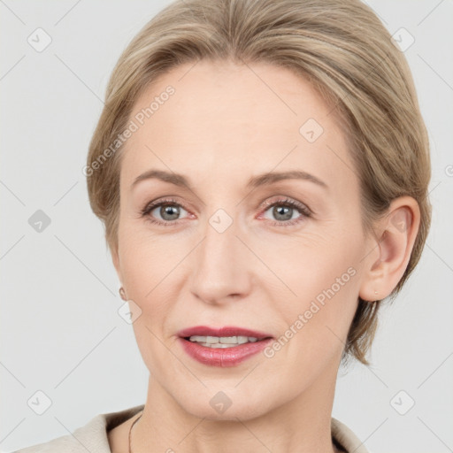 Joyful white adult female with medium  brown hair and grey eyes