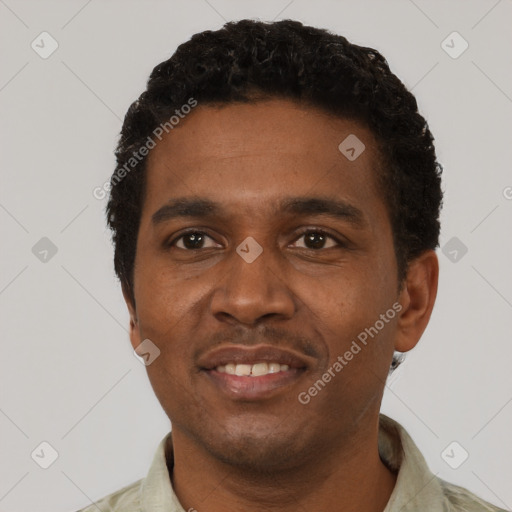 Joyful black young-adult male with short  black hair and brown eyes