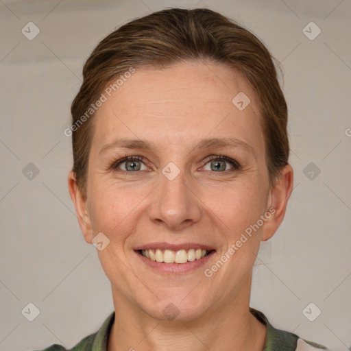 Joyful white adult female with short  brown hair and grey eyes