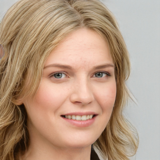 Joyful white young-adult female with long  blond hair and blue eyes