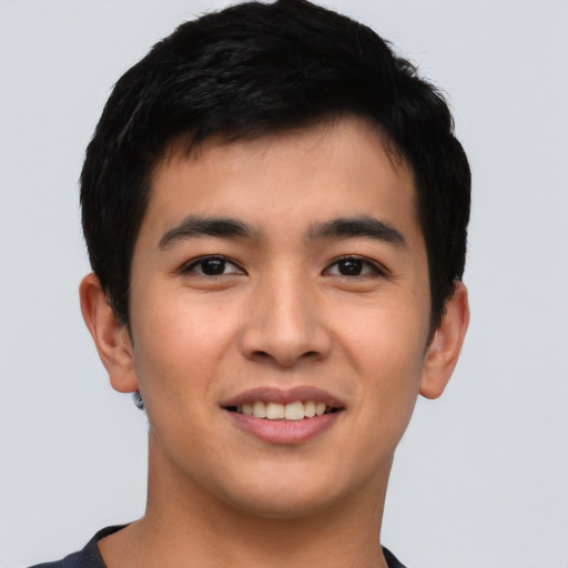 Joyful asian young-adult male with short  black hair and brown eyes