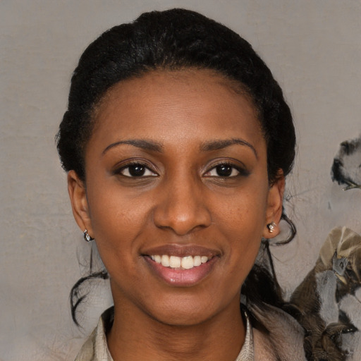 Joyful black young-adult female with medium  black hair and brown eyes