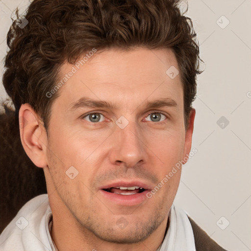 Joyful white adult male with short  brown hair and grey eyes