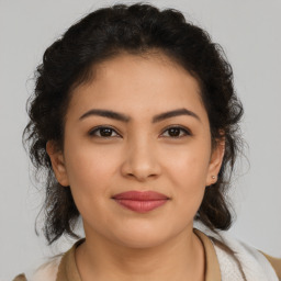 Joyful latino young-adult female with medium  brown hair and brown eyes