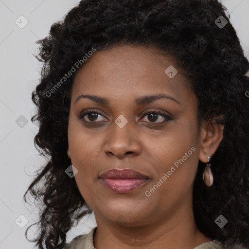 Joyful black young-adult female with long  brown hair and brown eyes