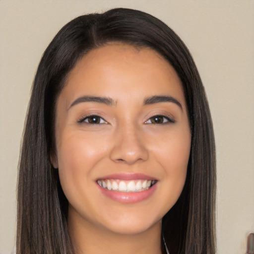 Joyful latino young-adult female with long  brown hair and brown eyes