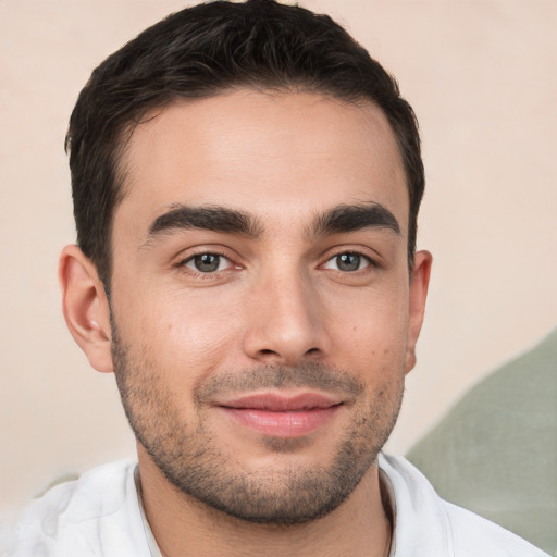 Joyful white young-adult male with short  brown hair and brown eyes