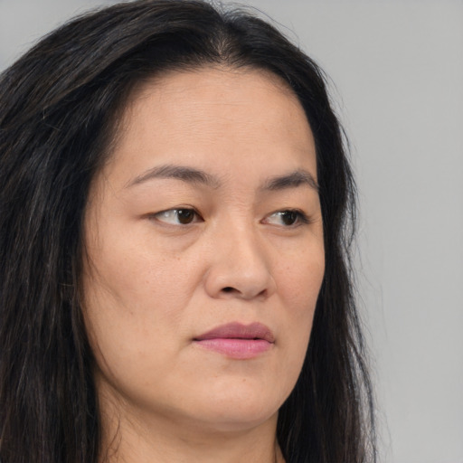 Joyful asian young-adult female with long  brown hair and brown eyes