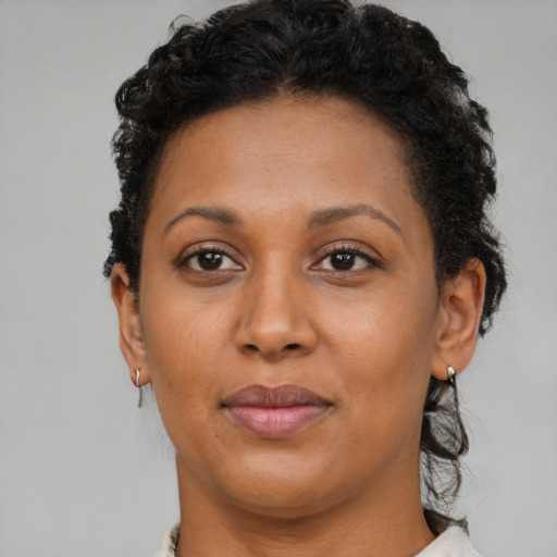 Joyful latino adult female with short  brown hair and brown eyes