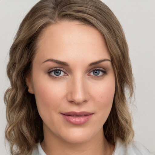 Joyful white young-adult female with medium  brown hair and green eyes