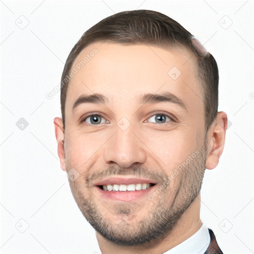 Joyful white young-adult male with short  brown hair and grey eyes