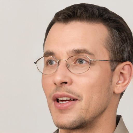 Joyful white adult male with short  brown hair and brown eyes