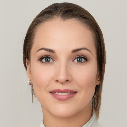 Joyful white young-adult female with medium  brown hair and grey eyes