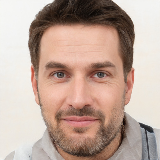 Joyful white adult male with short  brown hair and brown eyes