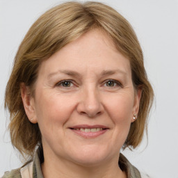 Joyful white adult female with medium  brown hair and grey eyes