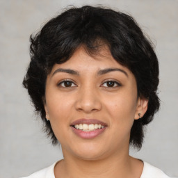 Joyful latino young-adult female with medium  brown hair and brown eyes