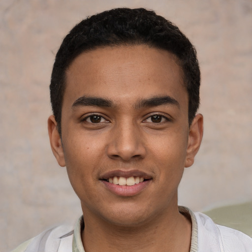 Joyful latino young-adult male with short  black hair and brown eyes