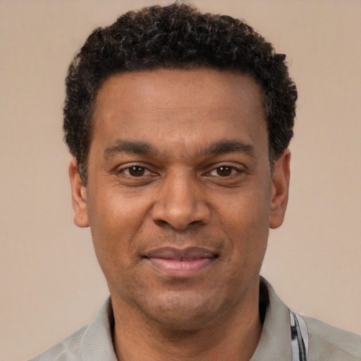 Joyful latino adult male with short  black hair and brown eyes
