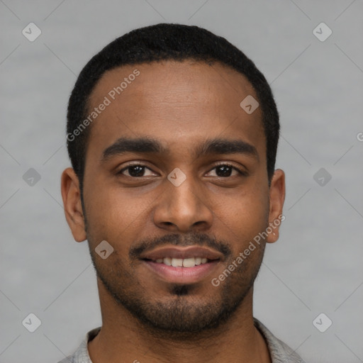 Joyful black young-adult male with short  black hair and brown eyes